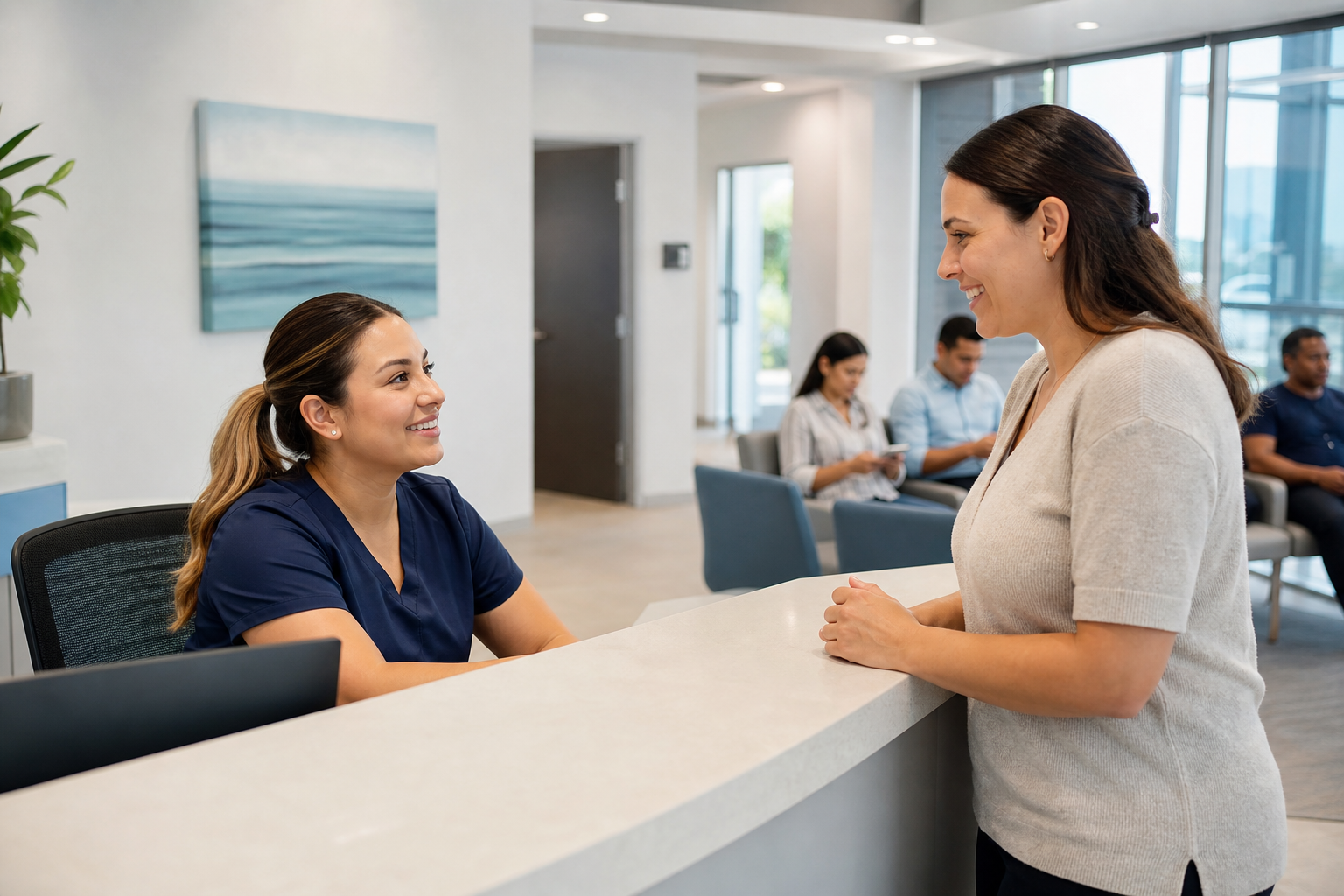 A friendly staff member assisting a patient at the front desk of Alief Primary Care